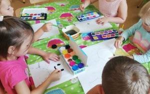 Grupa dzieci 4-l maluje farbami przy stoliku